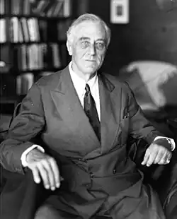 Roosevelt sitting in a chair and looking towards a camera