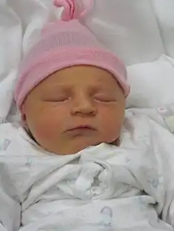 In the United States and Europe, baby girls are often dressed in pink and white.