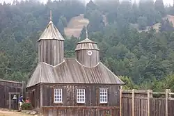 Reconstructed wooden chapel at Fort Ross, California, showing a small Russian Orthodox–style building within the former Russian colonial settlement.
