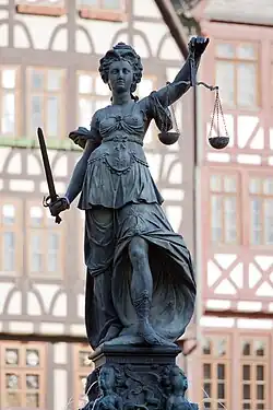 A sculpture of Lady Justice holding a sword and scales.