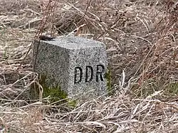An East German boundary stone with the letters "DDR" (Deutsche Demokratische Republik) carved on the western-facing edge.This one is at Freilandmuseum Behrungen, Thuringia