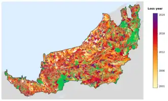 Map of Sarawak showing tree-cover loss years, with forest remaining since 2000 in green and loss years shaded yellow through purple.