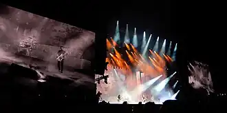 Gojira onstage, under orange and blue lights