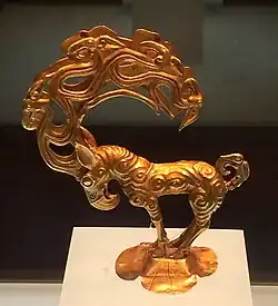 Gold stag with eagle's head, and ten further heads in the antlers. An object inspired by the art of the Siberian Altai mountain, possibly Pazyryk, unearthed at the site of Nalinggaotu, Shenmu County, near Xi'an, China.[105] Possibly from the "Hun people who lived in the prairie in Northern China". Dated to the 4th-3rd century BCE,[105] or Han dynasty period.[106] Shaanxi History Museum.[106]