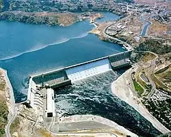 A large concrete dam holds back a reservoir.