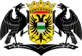 Two black eagles holding a crowned yellow shield