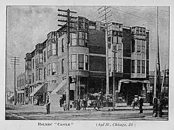 Three-story brick building with commercial storefronts on ground level