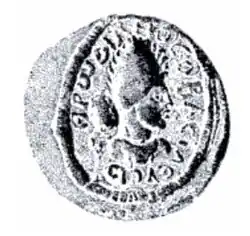 seal impression in the shape of a circle showing the head of a ruler wearing a tiara