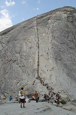 Hikers ascending the Half Dome cable route