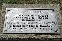 Metal plaque which reads: Time capsule interred November 1965 by the city of Hampton in honor of Christopher Columbus Kraft Jr. pioneer of U.S. space program to be opened November 2065