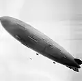 A large airship above a packed stadium