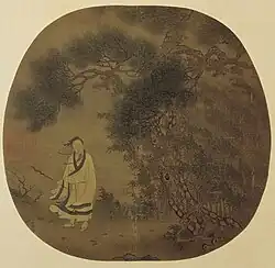 An oval painting mounted on a square background depicting a man in a white robe, holding a small stick, next to a tree. Strong wind blows everything in the painting leftward. The painting is done mainly in green tones.