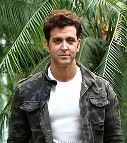 Hrithik Roshan is looking towards the camera.