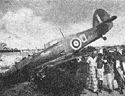 Crashed aeroplane with onlookers