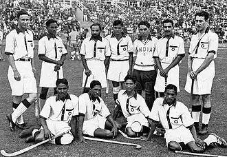 The Indian hockey team, captained by Dhyan Chand (standing second from l.), after winning the finals at the 1936 Summer Olympics – their third of six consecutive Olympic golds