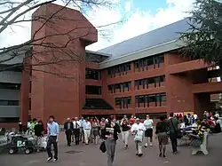 The intercultural center looms behind Red Square. Dozens of students are pictured in the plaza, many passing through, others sitting at tables demonstrating