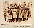 Non-eunuch slaves were sometimes assigned to the Qajar elite armies. The 14 slaves in this photo belonged to Prince Zell-e Soltan of Qajar, Ghameshlou, Isfahan, 1904[15].