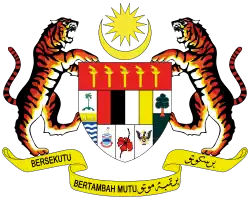 Shield showing the symbols of the Malaysian states with a star and crescent above and a motto below, supported by two tigers