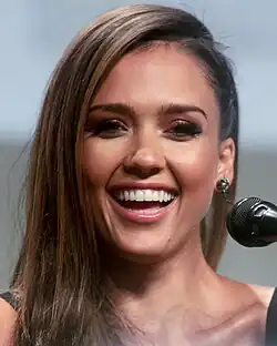 A portrait shot of Jessica Alba, an attractive woman with long brown hair, smiling