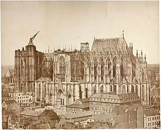 The unfinished cathedral in 1855. The medieval crane was still in place, while construction for the nave had been resumed earlier in 1814.