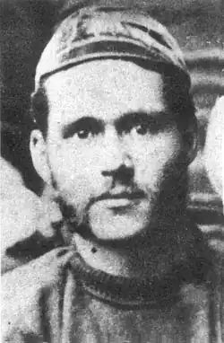 A man wearing an old-fashioned rugby cap