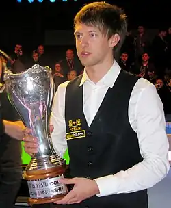 Judd Trump, holding the 2011 UK Championship trophy