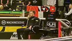 Judd Trump, sitting in a armchair