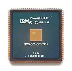 Green quad flack package with numerous pins on white background labeled with IBM logo, PowerPC 601 and 1992 copyright