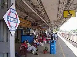 Station platform, with people waiting for a train