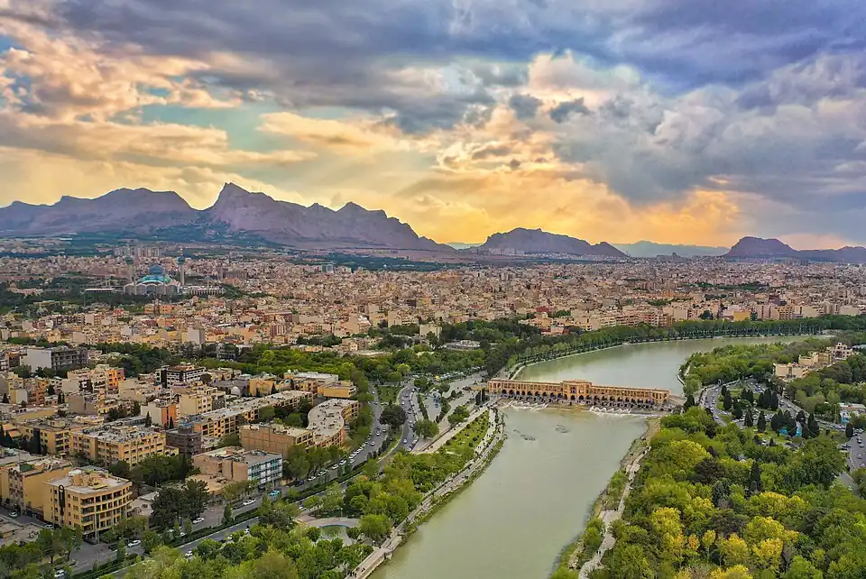 A bridge crossing a river in the middle of a city.