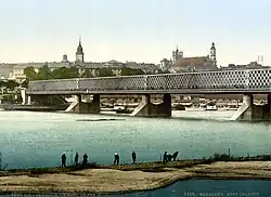 Kierbedź Bridge over the Vistula in Warsaw (c.&nbsp;1900). This framework bridge was constructed by Stanisław Kierbedź in 1850–1864. It was destroyed by the Germans in 1944.[49]
