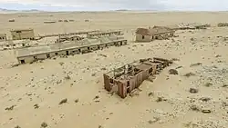 Sand-filled rooms inside abandoned buildings at Kolmanskop
