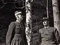 Crown Prince Olav and his father King Haakon VII take shelter under birch trees as the German Luftwaffe bombs Molde.
