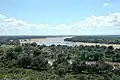 Taken from South Africa, to the left is Botswana and Zimbabwe is on the right. The river running from left to right is the Limpopo River. The river which disappears on the horizon is the Shashe
