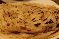 A round flatbread with flaky layers that come apart.