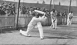 A cricketer hitting a ball