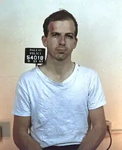 Colored mug shot of Oswald standing
