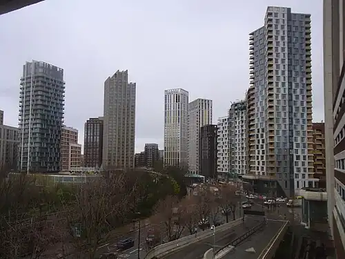 The emerging cluster in Lewisham also known as Lewisham Gateway, and first Borough of Sanctuary,[520] which includes 209 Connington Road Tower at 117&nbsp;m tall which is the white building in the centre and Lewisham Exchange at 105&nbsp;m tall to the left of it. All of the high-rises shown in this picture are residential with the exception of the grey building shown in the immediate right foreground which was formerly the London offices of Citigroup until they relocated to 25 Canada Square at Canary Wharf in 2001
