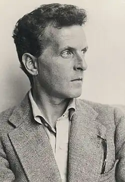 Photo of a man with short hair wearing a suit