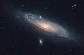 A visible light image of the Andromeda Galaxy and two satellite galaxies. Messier 32 is above the galactic nucleus and Messier 110 is at the bottom.