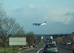 plane flying over motorway