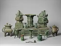A set of bronze ritual vessels arranged in a museum display