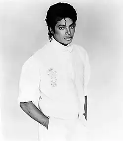 Black and white picture of Michael Jackson singing into a microphone