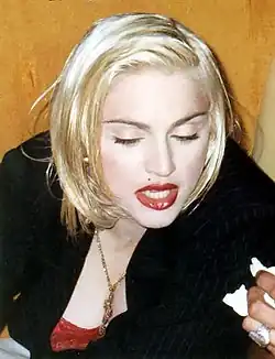 A blond woman looking down