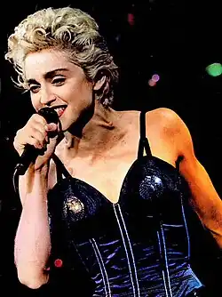 Madonna singing with a mic in her hand.