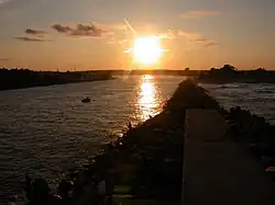 The Jersey Shore extends inland from the Atlantic Ocean into its many inlets, including Manasquan Inlet, looking westward at sunset from the jetty at Manasquan.