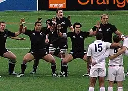 McCaw in the middle of the New Zealand haka facing a line of the French team in white