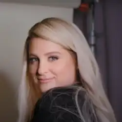 Trainor glancing over her left shoulder towards a camera