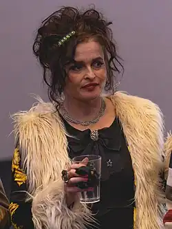 Helena Bonham Carter onstage, holding a cup