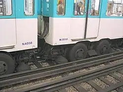 Paris Métro. The guide rails on the rubber-tyred lines also function as current conductors. The horizontal contact shoe is between the pair of rubber wheels.